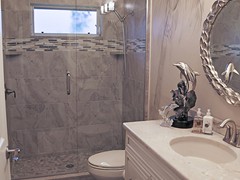 Tile and Glass Shower, Pebble Stone Floor and Window for Natural Light
