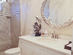Tile and Glass Shower, Pebble Stone Floor, Custom Cabinets, MOEN Fixtures