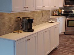 Under cabinet LED tape light and 6" LED puck lights in ceiling.